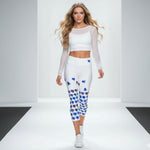 Load image into Gallery viewer, Woman wearing a white outfit with blue floral patterns on a plain background
