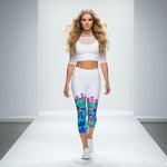 Load image into Gallery viewer, Woman walking on a runway wearing a white outfit with colorful leggings.
