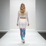 Load image into Gallery viewer, Woman wearing a white athletic outfit with colorful leggings on a plain background
