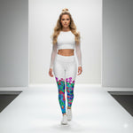 Load image into Gallery viewer, Woman wearing a white outfit with colorful leggings Flowers and pickleballs on a runway.
