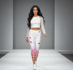 Load image into Gallery viewer, Model wearing Pickleball Love in Full Swing high-waisted capris with pink-to-red heart gradient design and UPF 50+ sun protection, front view on white runway background.
