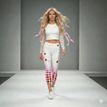 Load image into Gallery viewer, Model wearing Pickleball Love in Full Swing high-waisted capris with pink-to-red heart gradient design and UPF 50+ sun protection, front view on white runway background.
