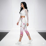 Load image into Gallery viewer, Side view of model wearing Pickleball Love in Full Swing high-waisted pickleball capris featuring a heart gradient design and UPF 50+ protection.
