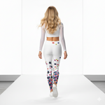 Load image into Gallery viewer, Woman wearing a white long-sleeve top and colorful polka dot leggings on a white platform.
