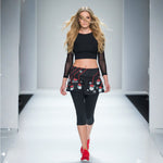 Load image into Gallery viewer, Model walking on a runway wearing a black outfit with red and white patterns.
