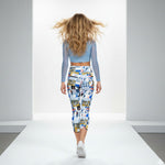 Load image into Gallery viewer, Woman walking on a runway wearing a blue top and colorful patterned pants.

