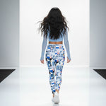 Load image into Gallery viewer, Woman wearing a light blue long-sleeve top and patterned leggings on a plain background
