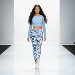 Load image into Gallery viewer, Woman wearing a light blue crop top and patterned leggings on a white background
