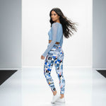 Load image into Gallery viewer, Woman wearing a light blue long-sleeve top and patterned leggings on a white background
