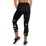 Load image into Gallery viewer, Back view of women's high-waisted tennis and padel capris in black with flowers and tennis balls
