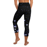 Load image into Gallery viewer, Back view of women's high-waisted tennis and padel capris in black with flowers and tennis balls
